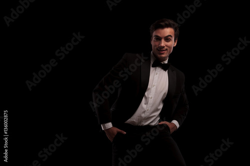 smiling young elegant man in tuxedo and bowtie