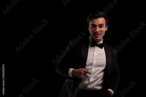 laughing young stylish man in tuxedo suit