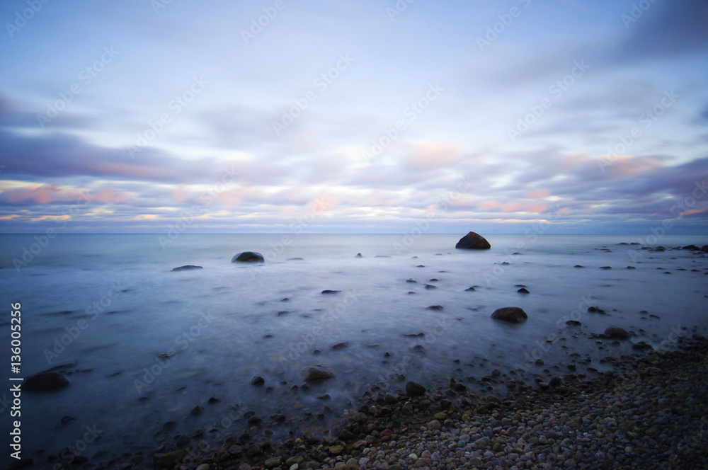 Obraz premium stony coast at sunrise, long time exposure, Baltic Sea Coast, Ruegen Island, Germany, Europe