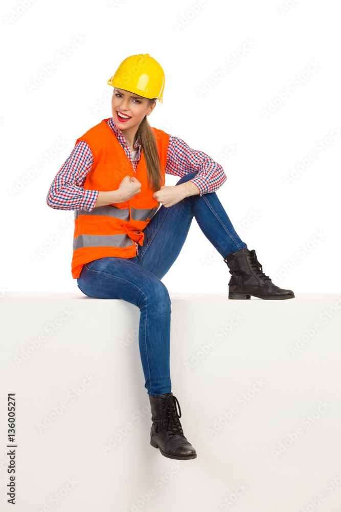 Strong Female Construction Worker Sitting On A Top Strong Female Construction Worker Sitting On A Top