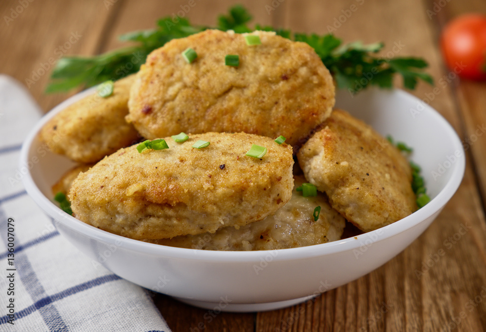 Chicken cutlets with vegetables on a wooden background Chicken cutlets with vegetables on a wooden background