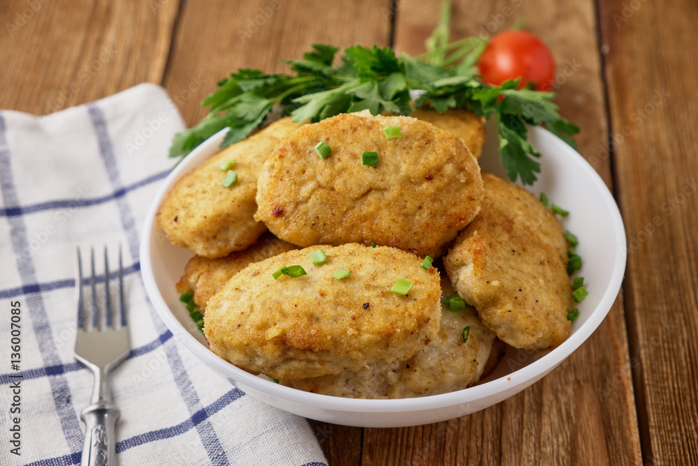Chicken cutlets with vegetables on a wooden background Chicken cutlets with vegetables on a wooden background