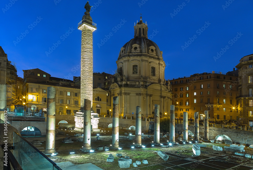 Rome, Italy. The ruins of the Forum of Trajan, 100 - 112 years AD. Trajan's Column (113) and the Church of the Holy Name of Mary (1736 - 1738). Night lights
