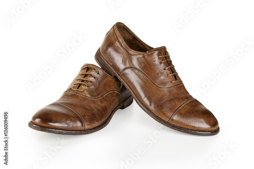 Pair of brown leather men shoes isolated on white. Men Brown Shoes. Stylish brown leather shoes. Men's classic brown leather shoes isolated on white background.
