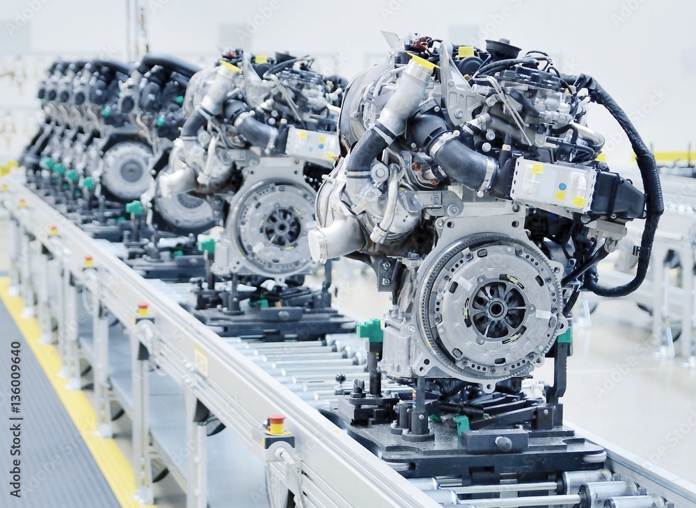 New manufactured car engines on automated production assembly line in a car factory. Manufacture of the engines for new car. New automotive engine on production line.