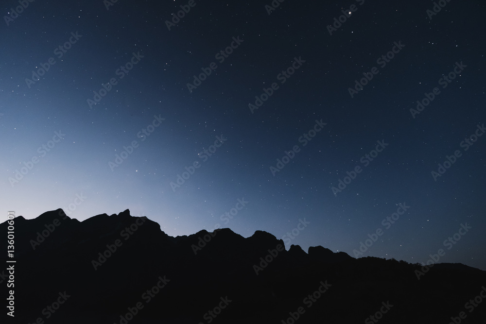 Silhouette mountains line, with clear sky full of star in dawn