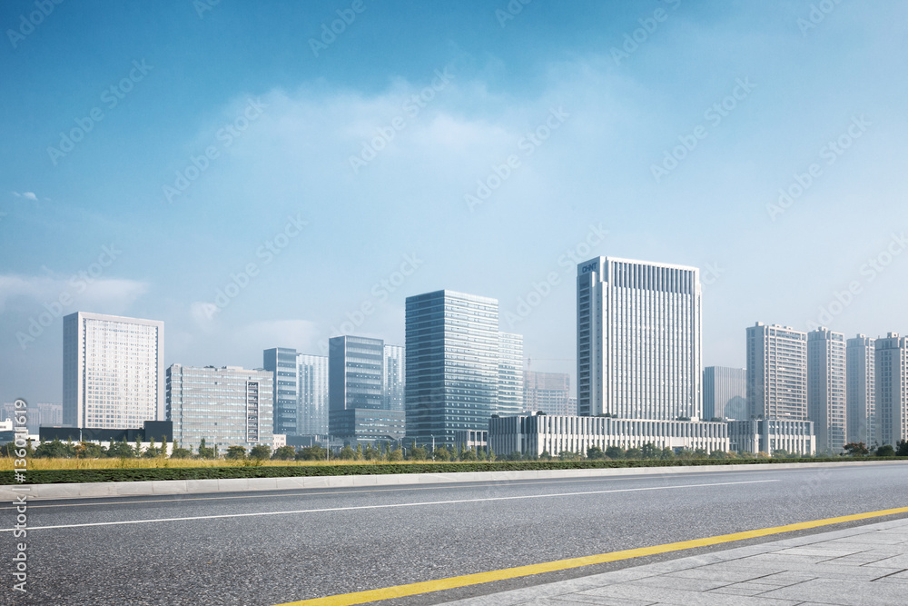 cityscape and skyline of modern city from empty road