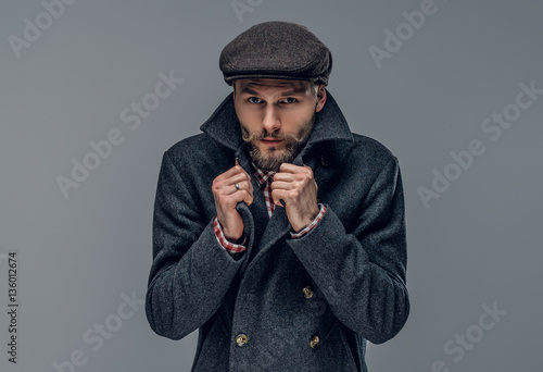 A man in a jacket on grey background. photo