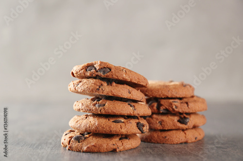 Delicious cookies with chocolate crumbs on grey table