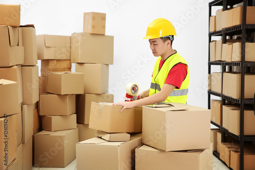 Man packing parcels with st...