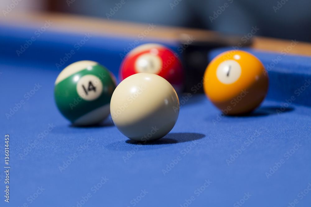 White, yellow, green and red billiard balls in a pool table White, yellow, green and red billiard balls in a pool table