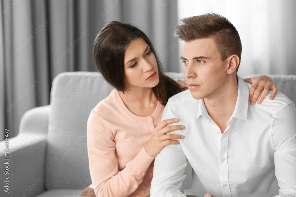 Young depressed man with girlfriend at home Young depressed man with girlfriend at home