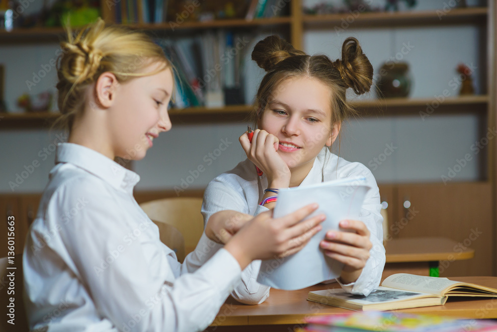 Φωτογραφία Teen girls in the school library or classroom, discussing what they are learning