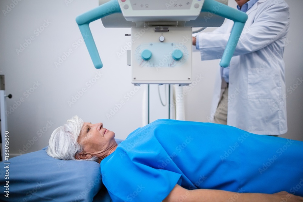 Senior woman undergoing x ray test in hospital Senior woman undergoing x ray test in hospital