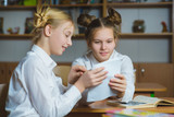Teen girls in the school library or classroom, discussing what they are learning