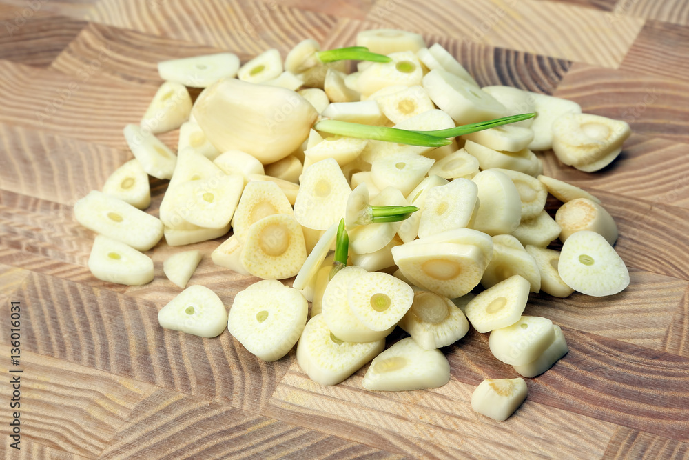 chopped garlic on a wooden table. chopped garlic on a wooden table.