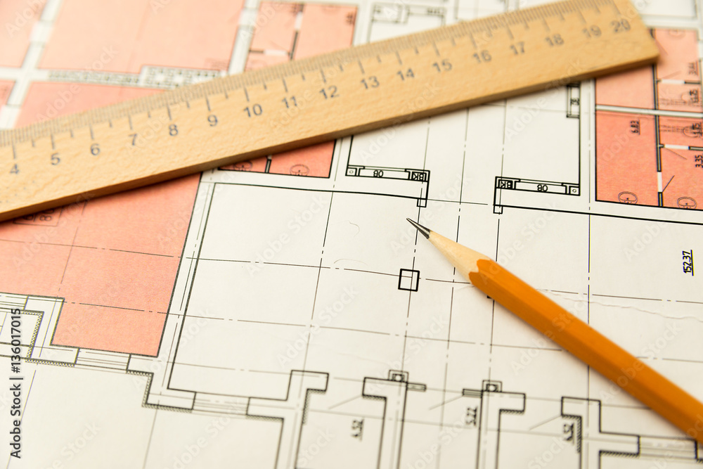 On the sheet is a pencil with a wooden ruler On the sheet is a pencil with a wooden ruler