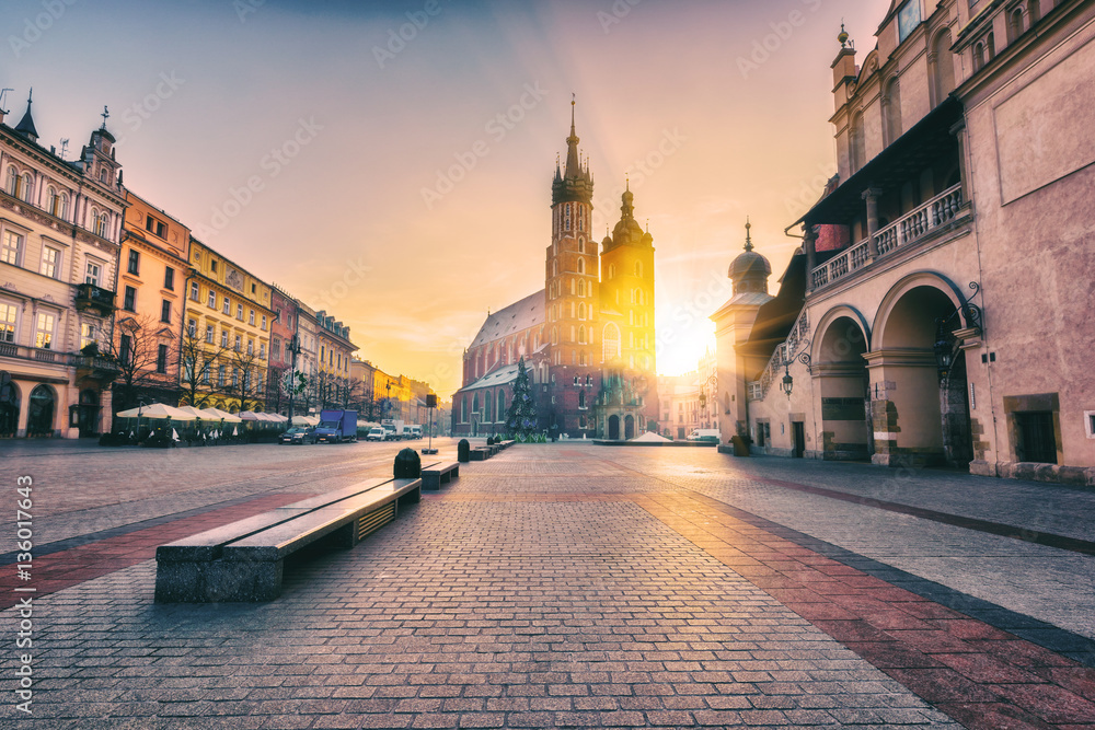 Krakow, main architectural ensemble, amazing colors of sunrise over the old town Market square, St. Mary's church (Mariacki cathedral) and Cloth Hall (Sukiennice), Poland, Europe - obrazy, fototapety, plakaty 