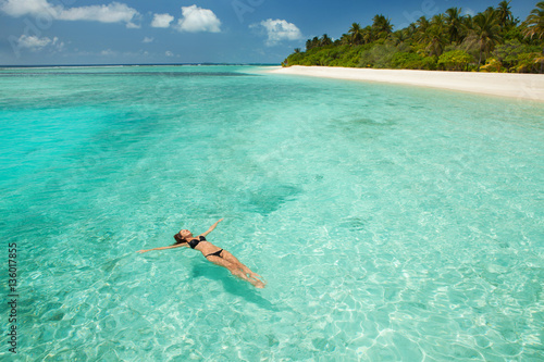 Woman swim and relax in the sea. Happy island lifestyle. White s