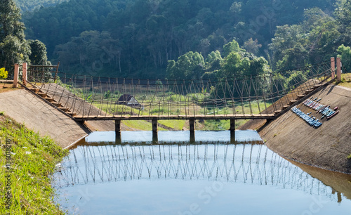 Wooden bridge over on reservoir