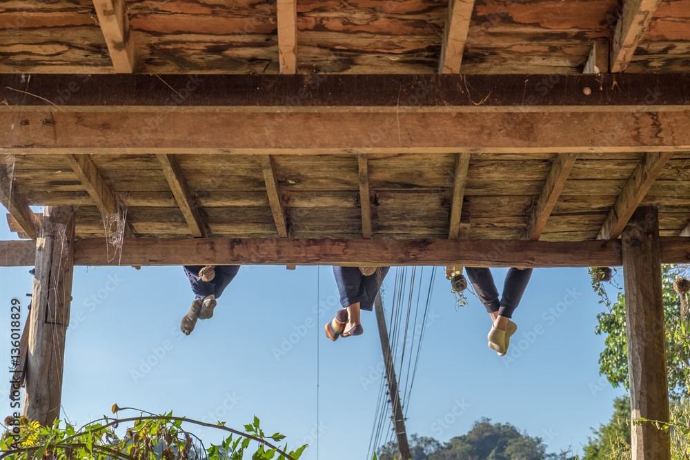 Tourists group sitting hanging legs on terrace