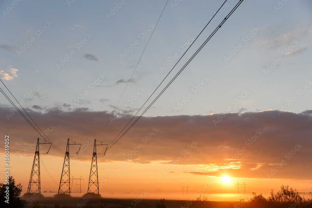 Power lines on purple sky