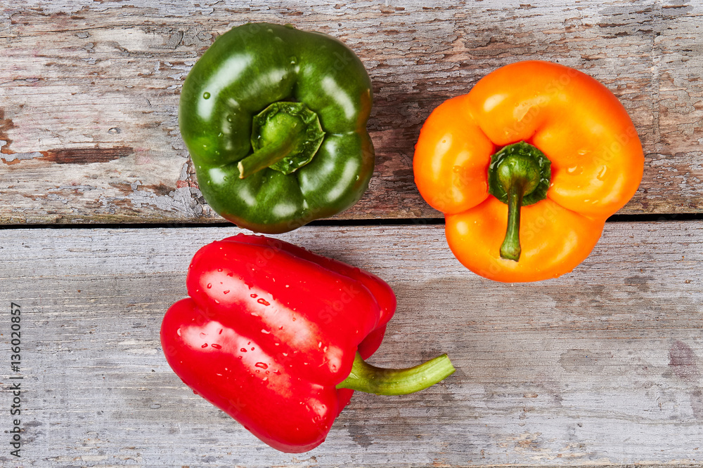 Bell peppers on wooden backdrop. Bell peppers on wooden backdrop.