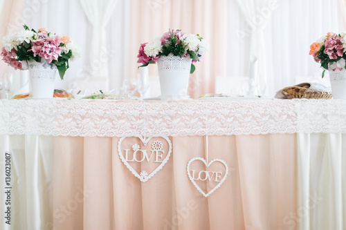 Decorative hearts with letterings  Love  inside hang from dinner table