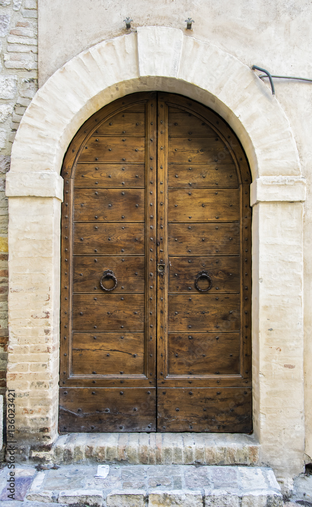 The entrance wooden door in an old Italian house. The entrance wooden door in an old Italian house.