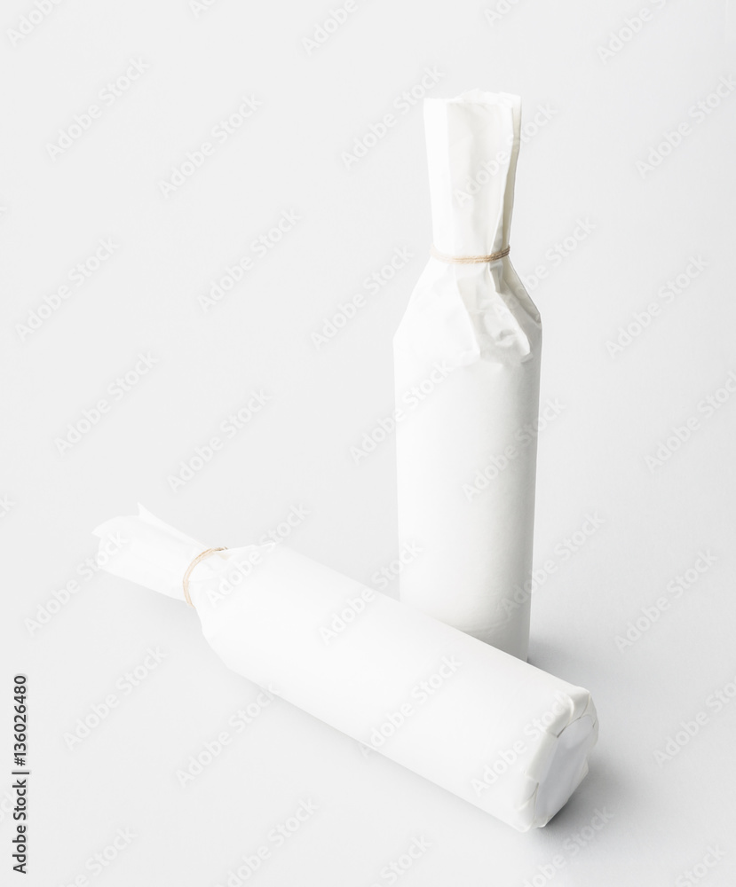 Two wine bottle are standing on gray background Two wine bottle are standing on gray background
