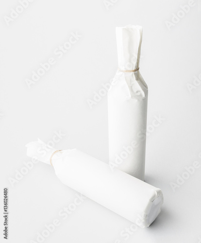 Two wine bottle are standing on gray background