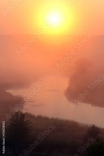 Misty sunrise over a small river