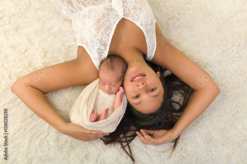 Smiling young mother with newborn baby