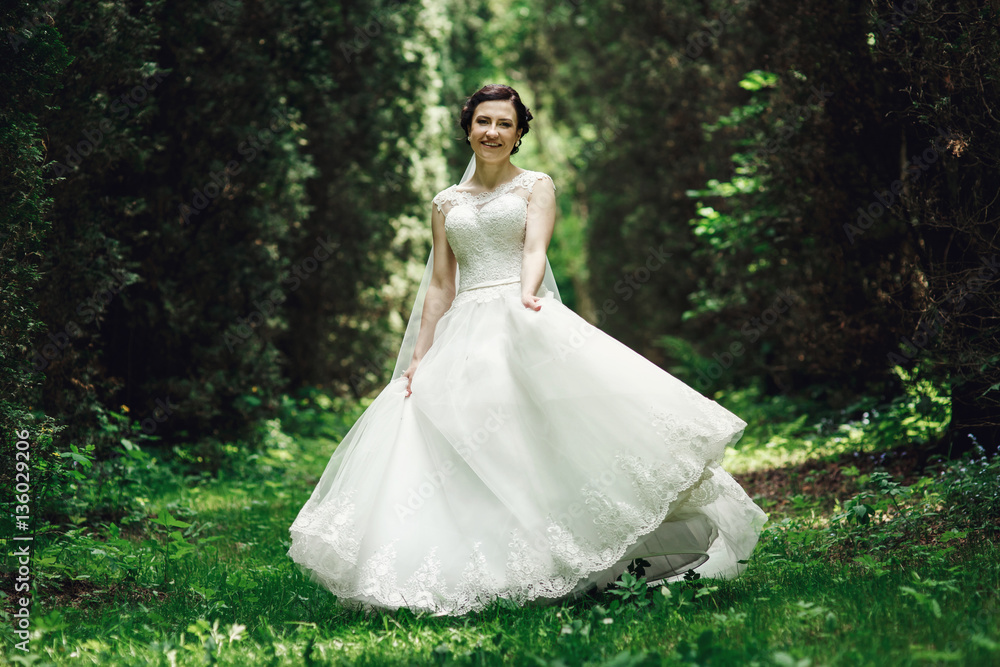 Bride smiles charming whirling in the forest Bride smiles charming whirling in the forest