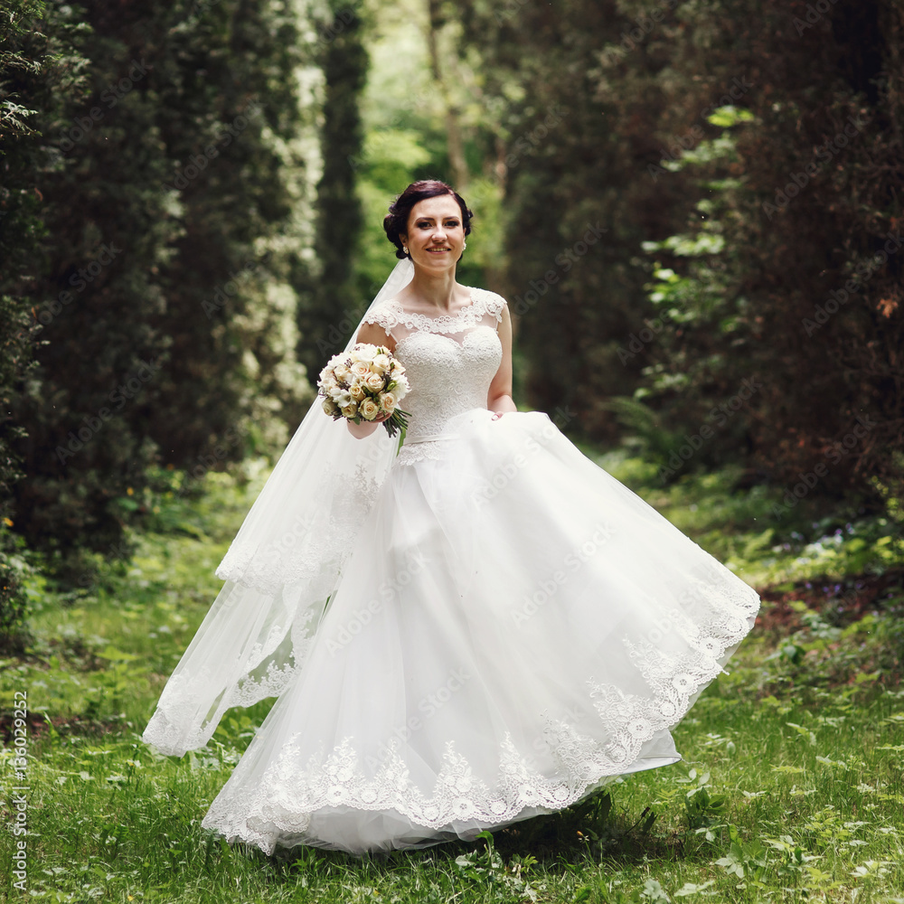 Pretty brunette bride whirls in dense forest Pretty brunette bride whirls in dense forest