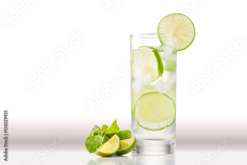Full glass of water with lemon and mint isolated on white backgr