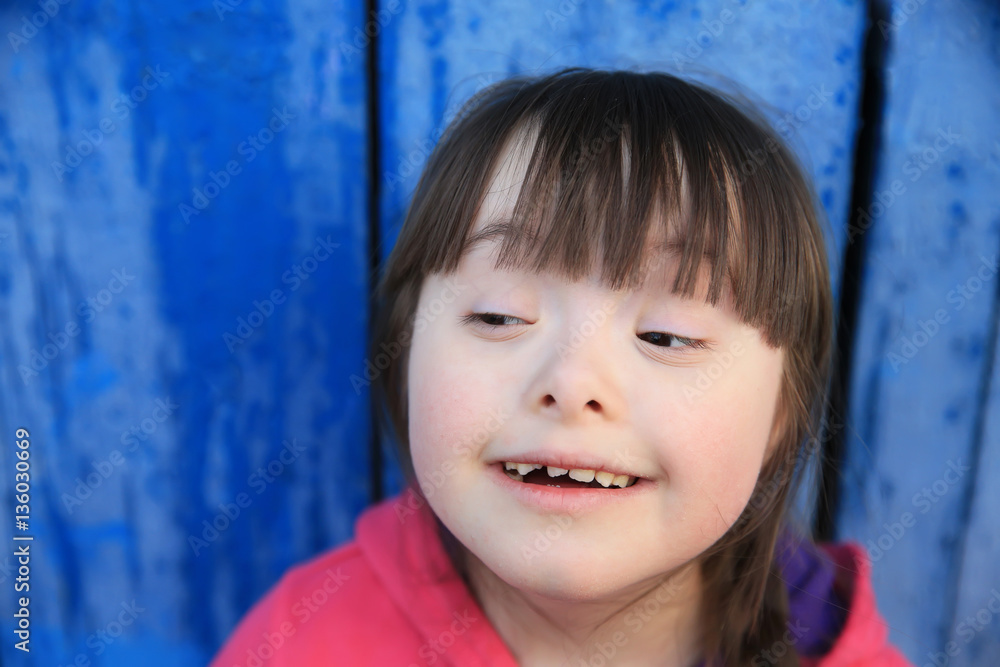 Young girl smiling on background of the blue wall. Young girl smiling on background of the blue wall.