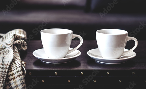 two white cups of morning coffee on the table