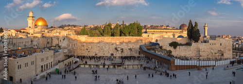 Temple Mount panoramic view in the old city of Jerusalem at sunset, including the Western Wall and golden Dome of the Rock. 