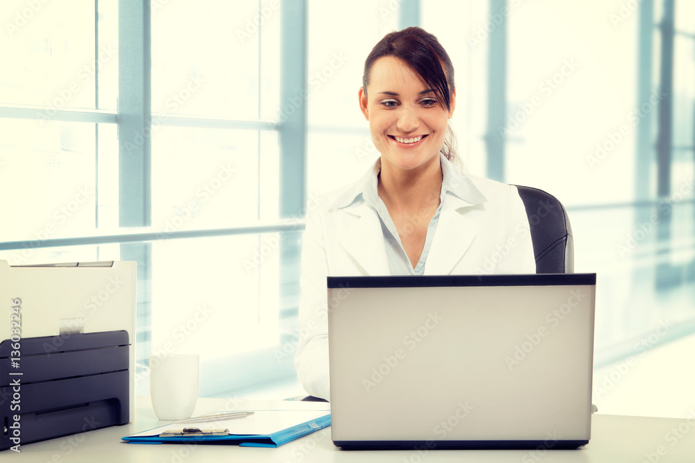 Young attractive business woman using laptop at the office Young attractive business woman using laptop at the office