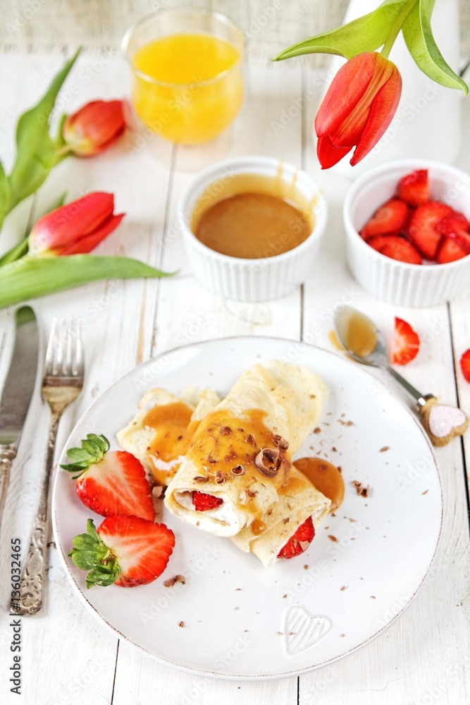 Coconut pancakes with strawberries and caramel
