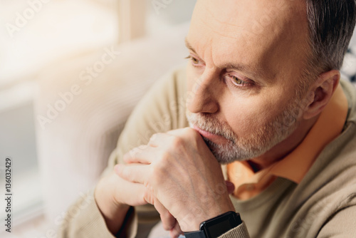 Male pensioner thinking seriously about something