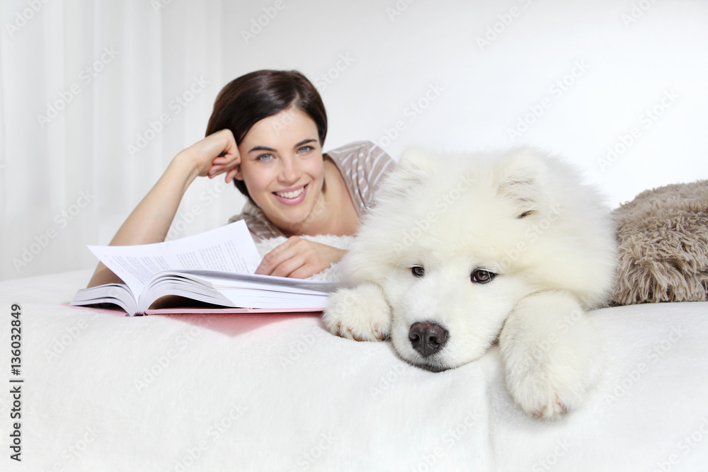 smiling woman with pet dog and book smiling woman with pet dog and book