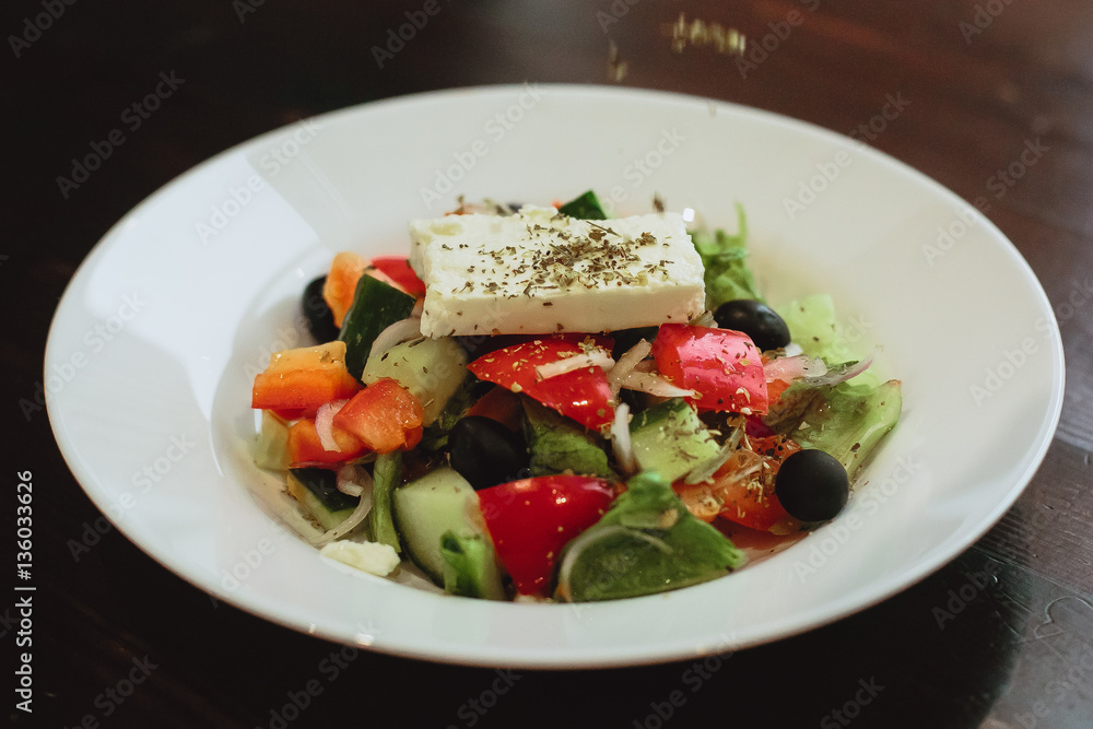 Greek salad with fresh vegetables, feta cheese and black olives Greek salad with fresh vegetables, feta cheese and black olives
