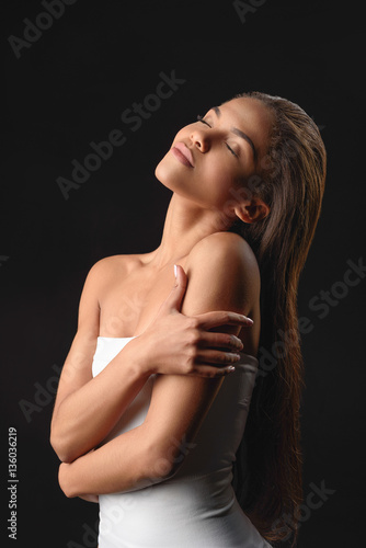 Sensual african woman enjoying skincare treatment