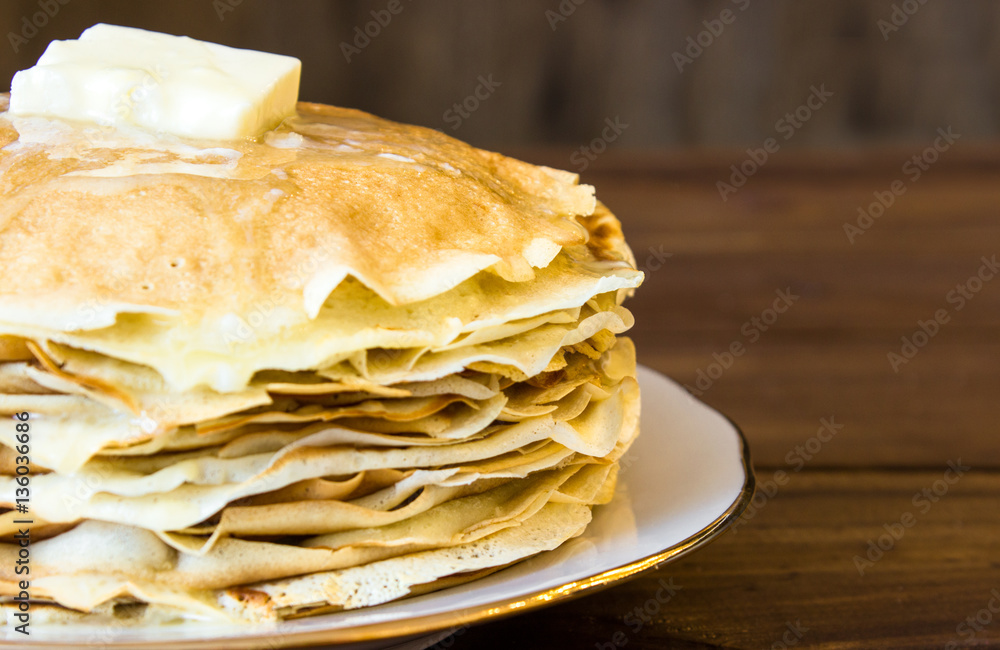 fresh homemade stack of crepes with butter