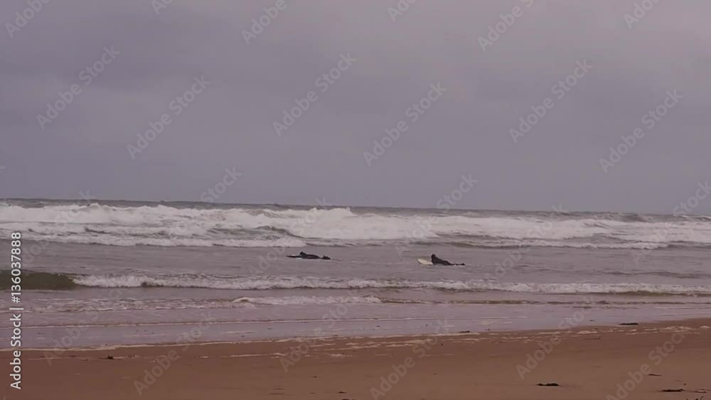 Surfboarders enjoying the waves on irish waters in the Republic of Ireland Surfboarders enjoying the waves on irish waters in the Republic of Ireland