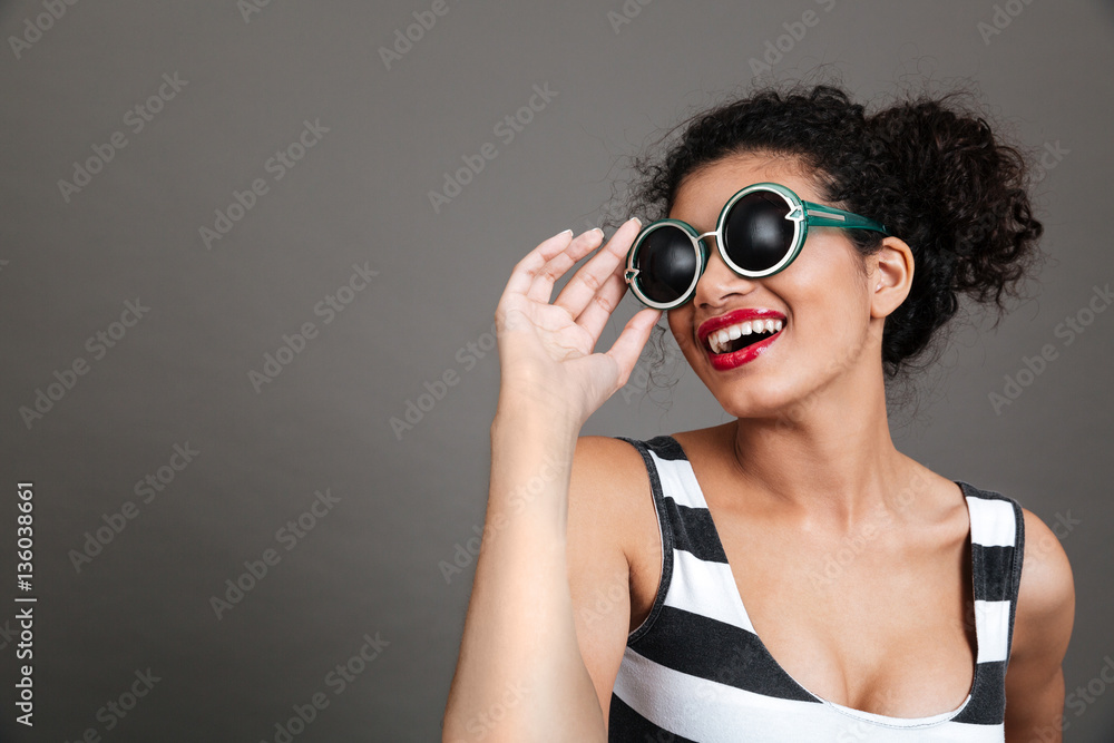 Portrait of smiling beautiful african american young woman in eyeglasses Portrait of smiling beautiful african american young woman in eyeglasses