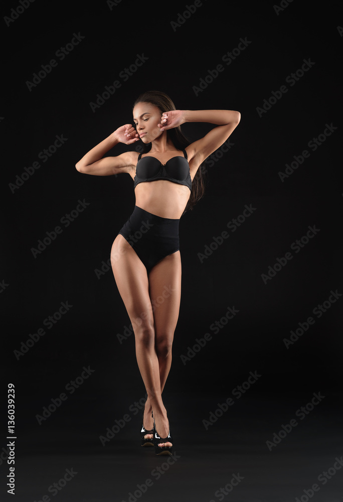 Confident female model posing on high heels