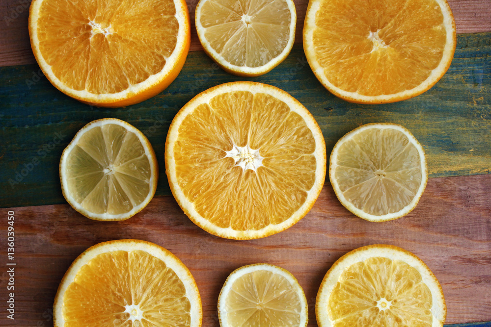 slices of lemon and orange on a wooden table slices of lemon and orange on a wooden table